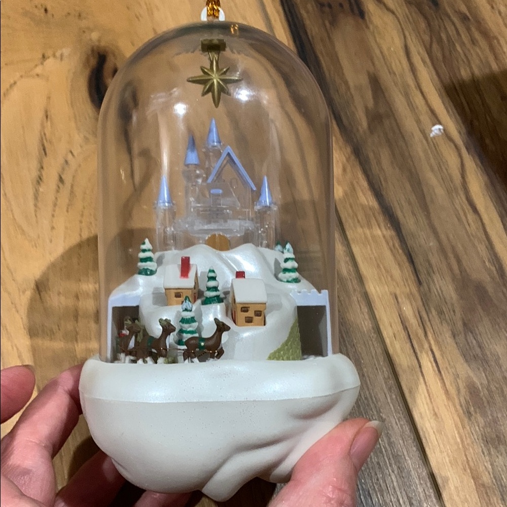 Hallmark or Disney like musical ornament w hole for inserting Christmas light